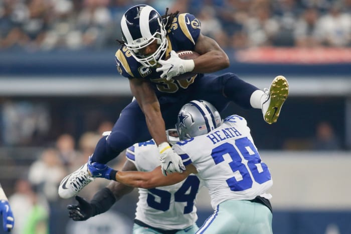 Rams running back Todd Gurley hurdles over Cowboys safety Jeff Heath during a 2017 game. Gurley is among the greatest running backs in Rams history.